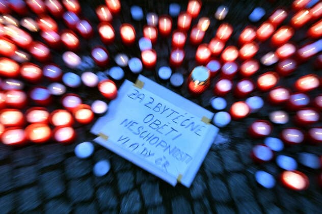 People layd down candles during the rally of group Let Us Stop COVID called Let Us Save Lives, Let Us Stop Industry in front of the Government Office in Prague, Czech Republic, March 9, 2021. (CTKxPhoto MichaelaxRihova) CTKPhotoP202103090782201  mir 3