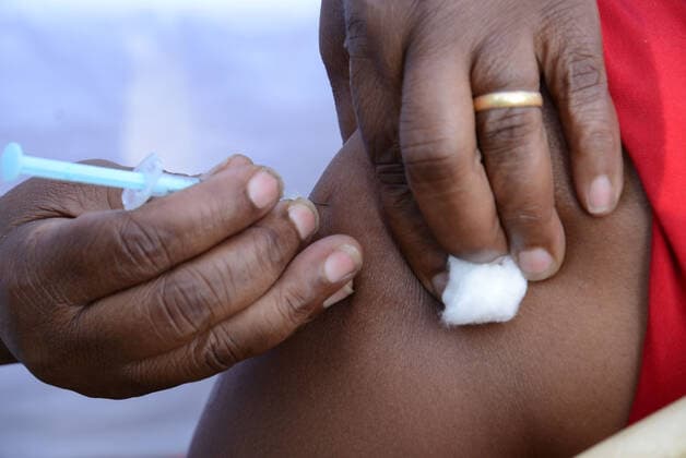 March 9, 2021, Nairobi, Kenya: A healthcare worker administers an Oxford AstraZeneca COVID-19 vaccine to her colleague at Mutuini Hospital in Nairobi. .Kenya on March 3, 2021 received its first batch of 1.02 million doses of Oxford AstraZeneca through global COVAX scheme as part of the 24 million doses the country is expected to import in a couple of months. The vaccine which is currently being distributed to various stations across the country will first be administered to healthcare workers, teachers and people whose immunity is compromised. Nairobi Kenya - ZUMAs197 20210309_zaa_s197_047 Copyright: xDennisxSigwex