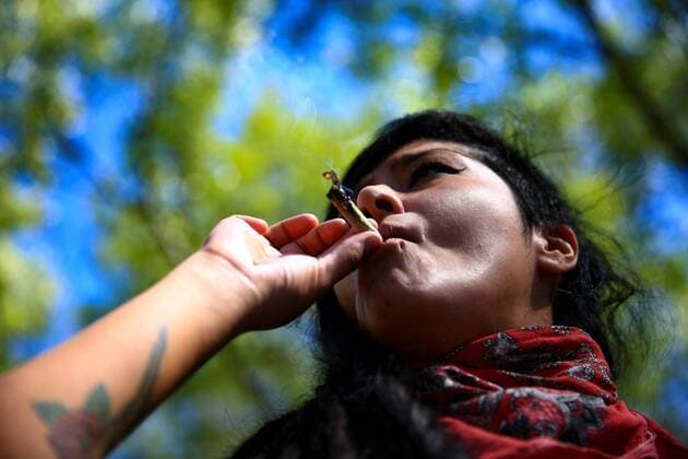 A woman smokes cannabis during a march for its full regularization, in Mexico City, Mexico, 09 March 2021. Activists and consumers marched this Tuesday to demand from legislators a law on cannabis recreational consumption that respects their rights, hours before the Chamber of Deputies votes on Wednesday the ruling that regulates the recreational use of marijuana. It is one of the main demands we have and one of our slogans: first the rights, then the market, activist Orlando Pacheco explained. Marijuana activists pressure the Mexican Congress within hours of its decision !ACHTUNG: NUR REDAKTIONELLE NUTZUNG!  Copyright: xCarlosxRamírezx MEX6640 20210310-637509405198806687