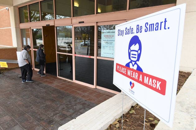 Patrons wear masks at a public library in Plano, Texas on Tuesday, March 9, 2021. Texas Gov. Greg Abbott fully rescinded the statewide mask order and is allowing business to reopen at full capacity effective March 10, 2021 leaving organizations and businesses to determine if they want to require customers to wear masks or not.  DAL2021030909 IANxHALPERIN