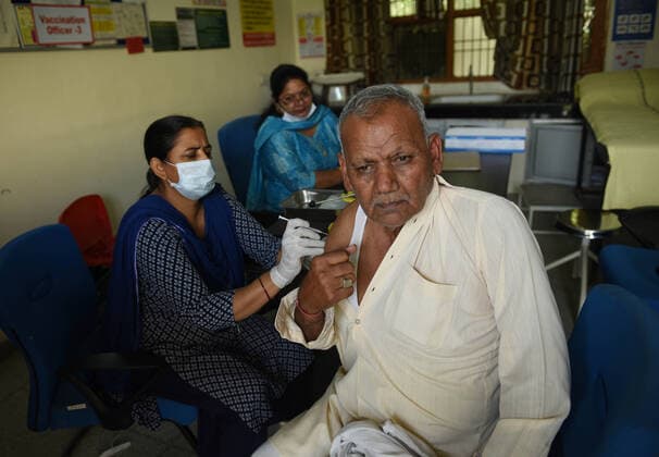 GURUGRAM, INDIA - MARCH 9: An elderly man gets vaccinated against Covid-19, at Urban Primary Health Centre, at Wazriabad, on March 9, 2021 in Gurugram, India. (Photo by Vipin Kumar Hindustan Times )