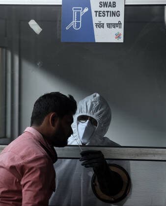 MUMBAI, INDIA - MARCH 9: A BMC health care worker collects a swab sample for Covid-19 test, at Dahisar, on March 9, 2021 in Mumbai, India. (Photo by Satish Bate Hindustan Times )