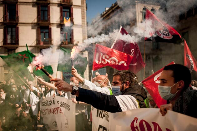 March 10, 2021, Barcelona, Spain: Healthcare workers protest amid smoke as they gather in Barcelona to demand an improvement in their working conditions aggravated by the coronavirus pandemic. Barcelona Spain - ZUMAb137 20210310_zap_b137_002 Copyright: xJordixBoixareux