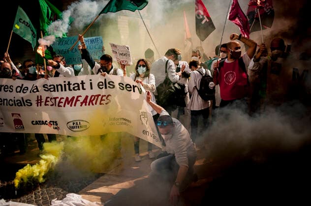 March 10, 2021, Barcelona, Spain: Healthcare workers protest amid smoke as they gather in Barcelona to demand an improvement in their working conditions aggravated by the coronavirus pandemic. Barcelona Spain - ZUMAb137 20210310_zap_b137_004 Copyright: xJordixBoixareux