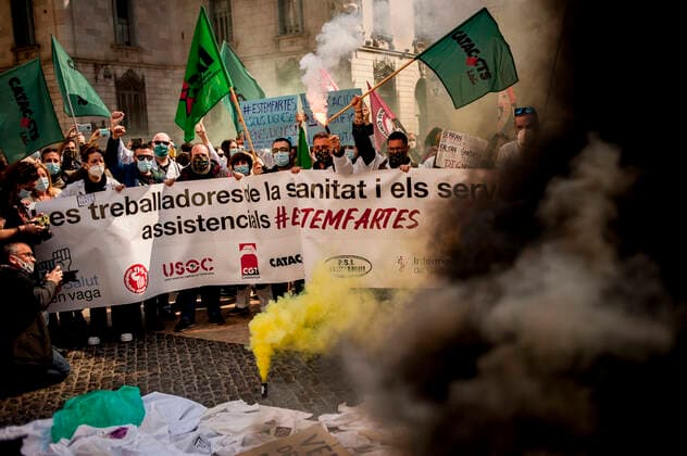 March 10, 2021, Barcelona, Spain: Healthcare workers protest amid smoke as they gather in Barcelona to demand an improvement in their working conditions aggravated by the coronavirus pandemic. Barcelona Spain - ZUMAb137 20210310_zap_b137_005 Copyright: xJordixBoixareux