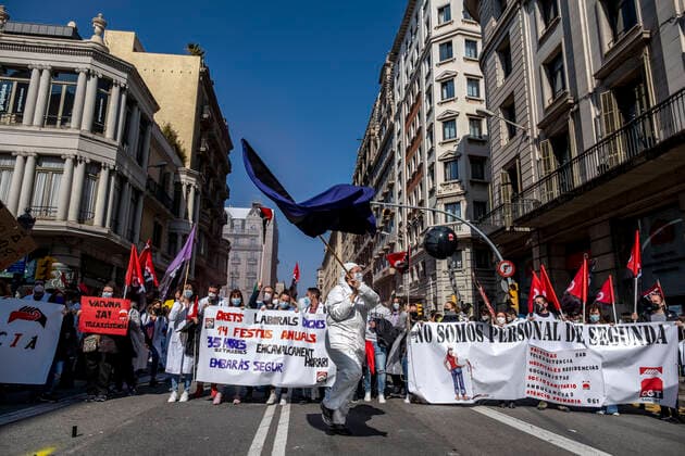 March 10, 2021, Barcelona, Catalonia, Spain: Protesters marching with huge banner at Via Laietana during the demonstration..Under the slogan estemfartes (we are fed up), the Catalan Health Union Board, formed by minority unions, has mobilized health workers to a day of strike to denounce the physical fatigue of health professionals and salary cuts. Barcelona Spain - ZUMAs197 20210310_zaa_s197_154 Copyright: xPacoxFreirex