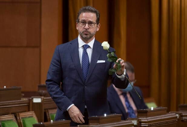 March 11, 2021, Ottawa, on, Canada: Bloc leader Yves-Francois Blanchet holds up a white rose as he rises to deliver a statement on the National Day of Observance of COVID-19, to recognize victims and the impacts of pandemic, in the House of Commons, in Ottawa, Thursday, March 11, 2021. Ottawa Canada - ZUMAc35_ 20210311_zaf_c35_004 Copyright: xAdrianxWyldx