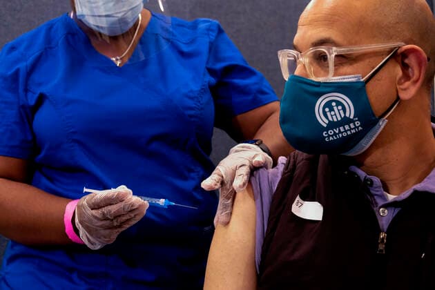 March 11, 2021, Los Angeles, California, USA: California Health and Human Services Secretary Dr. Mark Ghaly receives the new one-shot Johnson & Johnson COVID-19 vaccine from nurse LeShay Brown at a vaccination media event at Baldwin Hills Crenshaw Plaza in Los Angeles on March 11, 2021. The event was hosted by the California Department of Public Health and FEMA (Federal Emergency Management Agency). The Johnson & Johnson vaccine is now the third coronavirus vaccine to receive emergency approval for use in the United States. Los Angeles USA - ZUMAc68_ 20210311_zaf_c68_009 Copyright: xRingoxChiux