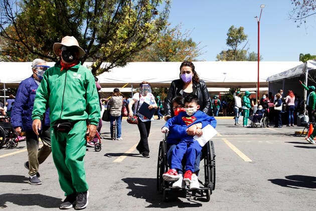 MEXICO CITY, MEXICO - MARCH 11: Staff of various social programmes, support to elderly over to move in wheelchairs to arrive at the facilities of the Autonomous Metropolitan University Azcapotzalco, where health workers apply the Pfizer BioNTech Covid19 vaccine to adults over 60 years of age, in the Third Stage of Vaccination. On March 11, 2021 in in Mexico City, Mexico.. Credit: Luis Barron Eyepix Group The Photo Access Increased COVID Vaccination for Elderly in Mexico  Copyright: xLuisxBarronx