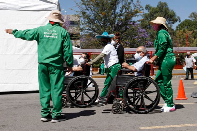 MEXICO CITY, MEXICO - MARCH 11: Staff of various social programmes, support to elderly over to move in wheelchairs to arrive at the facilities of the Autonomous Metropolitan University Azcapotzalco, where health workers apply the Pfizer BioNTech Covid19 vaccine to adults over 60 years of age, in the Third Stage of Vaccination. On March 11, 2021 in in Mexico City, Mexico.. Credit: Luis Barron Eyepix Group The Photo Access Increased COVID Vaccination for Elderly in Mexico  Copyright: xLuisxBarronx