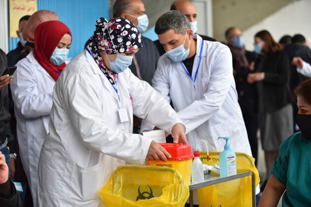 TUNIS, TUNISIA - MARCH 13: A healthcare personnel receives the first dose of the Sputnik V coronavirus (COVID-19) vaccine at a sahra hospital established in El Menzah Sports Palace as vaccination process begins in Tunis, Tunisia on March 13, 2021. NEWS : Debut du processus de vaccination a Tunis - 13 03 2021 WassimJdidi Panoramic 
