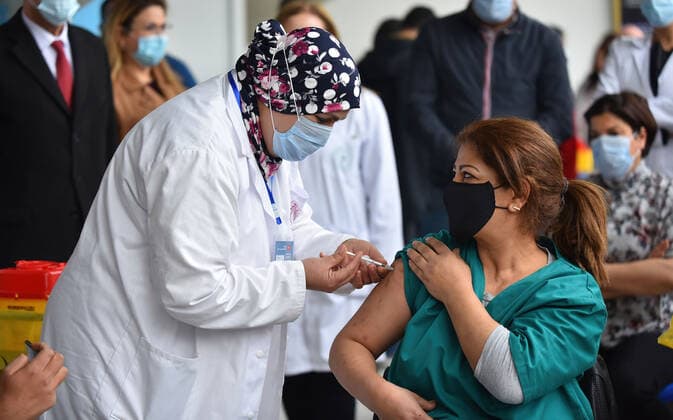 March 13, 2021, Tunis, Tunisia: A Tunisian nurse inoculates a health worker Mehrzia Hamami, the first dose of covid-19..The Tunisian government says that the aim of this session is to reach 50% of the country s population to vaccinate. The vaccine which is currently being distributed to various stations across the country will first be administered to healthcare workers, teachers and people whose immunity is compromised. Tunis Tunisia - ZUMAs197 20210313_zaa_s197_014 Copyright: xJdidixwassimx
