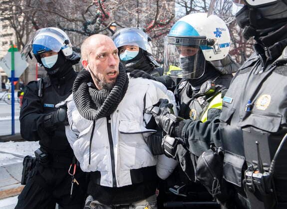 March 13, 2021, Montreal, PQ, Canada: A man is detained by police during a demonstration to oppose government restrictions to curb the spread of Covid-19 in Montreal, Saturday, March 13, 2021, as the COVID-19 pandemic continues in Canada and around the world. Montreal Canada  - ZUMAc35_ 20210313_zaf_c35_014 Copyright: xGrahamxHughesx