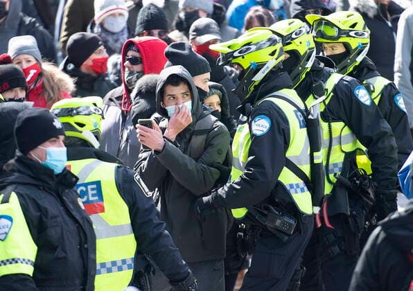 March 13, 2021, Montreal, PQ, Canada: Police remove a man from a demonstration opposing government restrictions to curb the spread of Covid-19 in Montreal, Saturday, March 13, 2021, as the COVID-19 pandemic continues in Canada and around the world. Montreal Canada  - ZUMAc35_ 20210313_zaf_c35_020 Copyright: xGrahamxHughesx