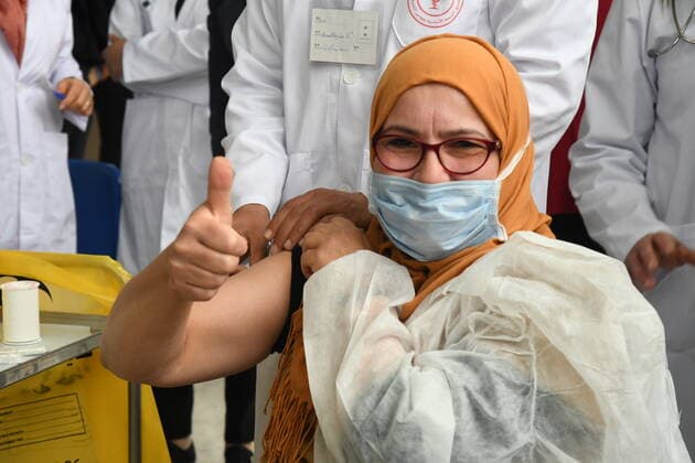 (210313) -- TUNIS, March 13, 2021 -- A woman gives a thumbs up as she receives the COVID-19 vaccine in Tunis, Tunisia, on March 13, 2021. The national vaccination campaign against COVID-19 officially started Saturday in the 25 regional centers across Tunisia. (Photo by Xinhua) TUNISIA-TUNIS-COVID-19 VACCINATION-CAMPAIGN AdelxEzzine 