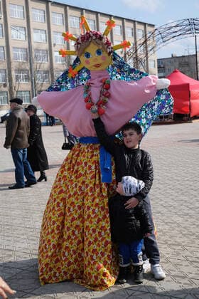 SIEVIERODONETSK, UKRAINE - MARCH 14, 2021 - A boy stands next to an effigy of Marena, the folklore character which symbolises the death and rebirth of nature in seasonal rituals, during the celebration of Pancake Week, or Masliana, Sievierodonetsk, Luhansk Region, eastern Ukraine. Pancake Week in Sievierodonetsk  Copyright: xOleksiixKovalovx