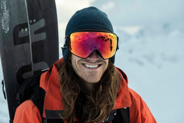 Portrait of smiling man in warm clothing carrying snowboard during vacation El brus, Kabardino-Balkarian Republic, Russia CR_BRHU210312A-678558-01 ,model released, Symbolfoto
