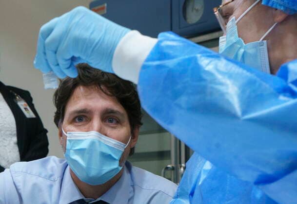 March 15, 2021, Montreal, PQ, Canada: Prime Minister Justin Trudeau looks at a COVID-19 vaccine vial as he tours a vaccination clinic in Montreal, on Monday, March 15, 2021. Montreal Canada  - ZUMAc35_ 20210315_zaf_c35_004 Copyright: xPaulxChiassonx