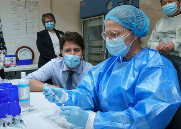 March 15, 2021, Montreal, PQ, Canada: Prime Minister Justin Trudeau watch as a COVID-19 vaccine syringe is prepared as he tours a vaccination clinic in Montreal, on Monday, March 15, 2021. Montreal Canada  - ZUMAc35_ 20210315_zaf_c35_005 Copyright: xPaulxChiassonx