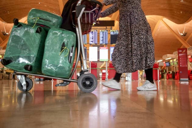 A woman walks with several suitcases on a trolley at terminal T4 of Adolfo Suarez Madrid-Barajas Airport in Madrid, Spain, on March 15, 2021. The Government has extended until March 30 the limitation of direct flights and passenger ships between the United Kingdom and Spanish airports and ports and flights between Brazil and the Republic of South Africa and Spanish aerodromes. The order, collected this Friday in the Official State Gazette (BOE), was approved in the Council of Ministers on Tuesday and extends the orders of 22 December 2020 and 2 February 2021, by which, respectively, the Executive established exceptional measures to limit the spread and spread of strains of COVID-19. 15 MARCH 2021;BRAZIL;SOUTH AFRICA;AIRPORT;UNITED KINGDOM;F Copyright: xRicardoxRubiox 3607707