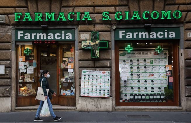 (210316) -- ROME, March 16, 2021 -- A woman wearing a face mask walks past a pharmacy on Via del Corso in Rome, Italy, March 15, 2021. Italy entered into a new period of semi-lockdown on Monday, with over half of its 20 regions falling into the red zone and subject to the maximum level of restrictions. ) ITALY-ROME-COVID-19-SEMI-LOCKDOWN ChengxTingting 