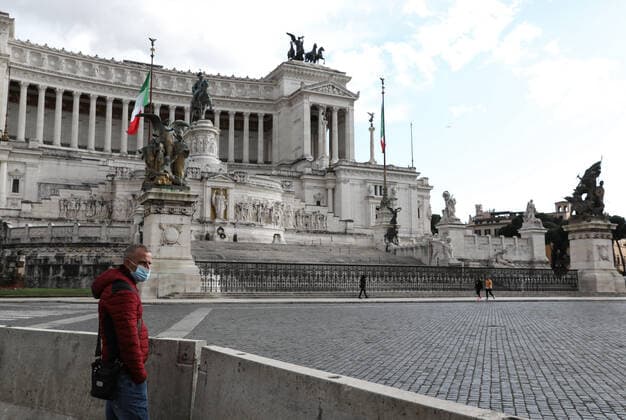 (210316) -- ROME, March 16, 2021 -- A man wearing a face mask stands at the Piazza Venezia in Rome, Italy, March 15, 2021. Italy entered into a new period of semi-lockdown on Monday, with over half of its 20 regions falling into the red zone and subject to the maximum level of restrictions. ) ITALY-ROME-COVID-19-SEMI-LOCKDOWN ChengxTingting 
