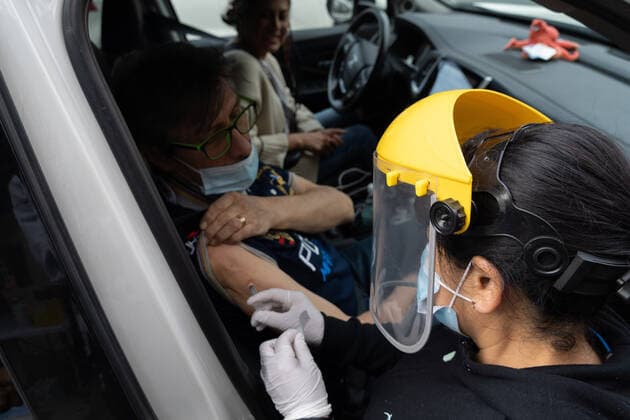 Coronavirus in Chile, Drive in Impfzentrum mit Sinovac Impfstoff in Santiago March 16, 2021, Santiago, Metropolitana, Chile: A man is vaccinated with a dose of the Sinovac COVID-19 vaccine at a drive-thru vaccination site in Santiago, Chile. So far, almost 5 million people have been vaccinated in the country, and 41% of them with the second dose. Santiago Chile - ZUMAb332 20210316_zip_b332_009 Copyright: xMatiasxBasualdox