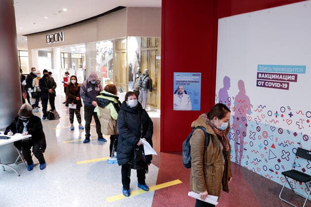 MOSCOW, RUSSIA - MARCH 17, 2021: Citizens queue outside a temporary COVID-19 vaccination site, a mobile team administering the Gam-COVID-Vac (Sputnik V) vaccine free of charge and without prior appointment at the Kuntsevo Plaza shopping centre in western Moscow. Mikhail Metzel TASS  TS0F99AF