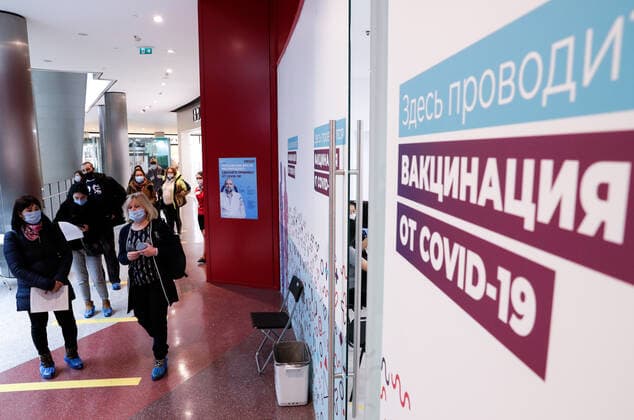 MOSCOW, RUSSIA - MARCH 17, 2021: Citizens queue outside a temporary COVID-19 vaccination site, a mobile team administering the Gam-COVID-Vac (Sputnik V) vaccine free of charge and without prior appointment at the Kuntsevo Plaza shopping centre in western Moscow. Mikhail Metzel TASS  TS0F99B1