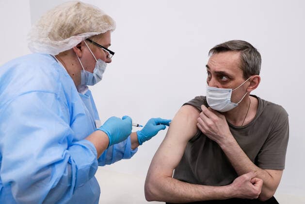 MOSCOW, RUSSIA - MARCH 17, 2021: A man receives an injection of the Gam-COVID-Vac (Sputnik V) vaccine at a temporary COVID-19 vaccination site, a mobile team giving injections free of charge and without prior appointment at the Kuntsevo Plaza shopping centre in western Moscow. Mikhail Metzel TASS  TS0F99B5