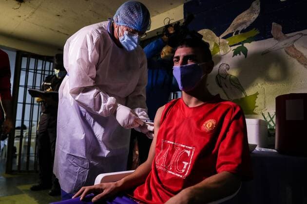 MONTEVIDEO (URUGUAY), 03 17 2021.- Inmates receive first dose of Chinese Coronavac vaccine, in the Uruguayan Santiago Vazquez prison (located on the outskirts of Montevideo), Uruguay, 17 March 2021. The gurises (boys) kamikaze , thus stigmatized by their guards, with problems of coexistence in the most conflictive prison in Uruguay and subjected to conditions many times below human dignity, gave an example of commitment and put their arms en masse to get vaccinated against covid-19. These young people, always singled out despite the fact that many of them are not deprived of liberty for serious crimes, walk among rats and suffer an overcrowding that has not been resolved for decades - to the point that many have to sleep on the frozen conc  Copyright: xFedericoxAnfittix AME3457 20210317-637516051095841503