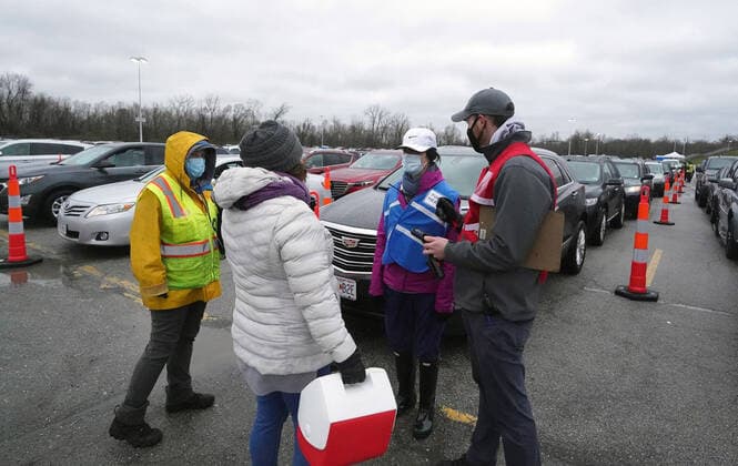 Vaccinators prepare to give Covid-19 vaccination shots at the Family Arena during a mass vaccination drive-in event in St. Charles, Missouri on Thursday, March 18, 2021. The event attracted 4,000 people, some waiting over four hours in their cars for their first shot to protect them from the coronavirus.  SLP2021031811 BILLxGREENBLATT
