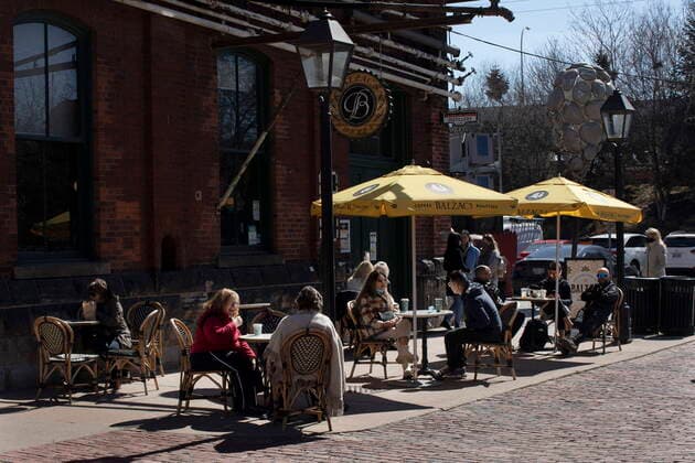March 20, 2021, Toronto, on, Canada: Customers sit on a patio at a coffee shop in the Distillery district in Toronto, Saturday, March 20, 2021. Starting today, restaurants in Toronto and Peel Region can offer customers outdoor dining. Toronto Canada  - ZUMAc35_ 20210320_zaf_c35_007 Copyright: xChrisxYoungx