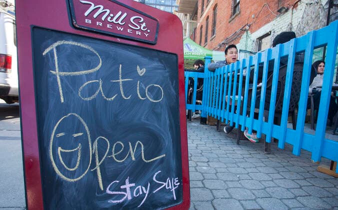 (210320) -- TORONTO, March 20, 2021 -- A notice of Patio Open is seen outside a restaurant in Toronto, Canada, on March 20, 2021. With distancing rules and a number of other public health and workplace safety measures, outdoor dining was allowed to resume Saturday in Toronto under modifications to the Ontario s color-coded pandemic response framework. (Photo by Xinhua) CANADA-TORONTO-COVID-19-OUTDOOR DINING-RESUME ZouxZheng 