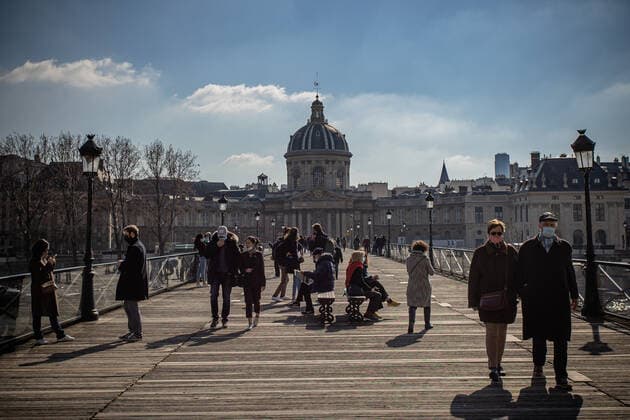 (210320) -- PARIS, March 20, 2021 -- People walk on the Pont des Arts bridge in Paris, France, on March 20, 2021. French Prime Minister Jean Castex on Thursday announced new massive measures to curb COVID-19 in the country s 16 worst-hit regions, including Paris. Starting Friday midnight, about 18 million French people in regions such as Paris, Hauts-de-France in the north as well as the Alpes-Maritimes on the Mediterranean should stay at home, Castex announced at a press briefing on the epidemic situation. (Photo by Xinhua) FRANCE-PARIS-COVID-19-PARTIAL LOCKDOWN AurelienxMorissard 