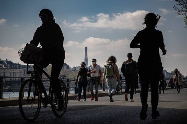 (210320) -- PARIS, March 20, 2021 -- People walk along the bank of Seine in Paris, France, on March 20, 2021. French Prime Minister Jean Castex on Thursday announced new massive measures to curb COVID-19 in the country s 16 worst-hit regions, including Paris. Starting Friday midnight, about 18 million French people in regions such as Paris, Hauts-de-France in the north as well as the Alpes-Maritimes on the Mediterranean should stay at home, Castex announced at a press briefing on the epidemic situation. (Photo by Xinhua) FRANCE-PARIS-COVID-19-PARTIAL LOCKDOWN AurelienxMorissard 
