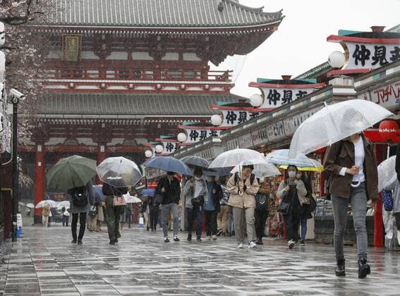 Virus emergency lifting People walk in the rain on Nakamise shopping street in Tokyo s Asakusa area on March 21, 2021, ahead of the scheduled lifting of the coronavirus state of emergency at the end of the day. 