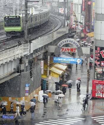 Virus emergency lifting People walk in the rain on Ameyoko shopping street in Tokyo s Ueno area on March 21, 2021, ahead of the scheduled lifting of the coronavirus state of emergency at the end of the day. 