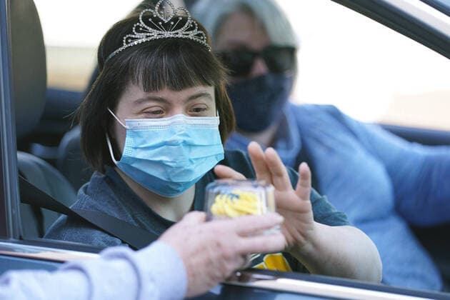 Bilder des Jahres 2021, News 03 März News Themen der Woche KW11 News Bilder des Tages Sara Geer takes a cupcake while she is driven through a parade on World Down Syndrome Day at the Down Syndrome Association of Greater St. Louis, in Brentwood, Missouri on Sunday, March 21, 2021. The 21st day of March was selected to signify the uniqueness of the triplication of the 21st chromosome which causes Down syndrome.  SLP2021032109 BILLxGREENBLATT