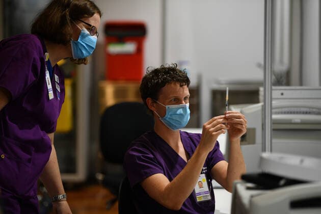 COMMUNITY COVID19 VACCINATION ROLLOUT, A healthcare worker is seen handling a AstraZeneca covid19 vaccination inside of vaccination centre at the Royal Exhibition Building in Melbourne, Monday, March 22, 2021. More than six million Australians are now eligible to receive coronavirus vaccines under a new phase of the national rollout. Phase 1b of the program kicked off across the country on Monday. ( NO ARCHIVING, EDITORIAL USE ONLY, NO USE IN BOOKS WITHOUT CONSENT MELBOURNE VIC AUSTRALIA  Copyright: xJAMESxROSSx 20210322001529290220