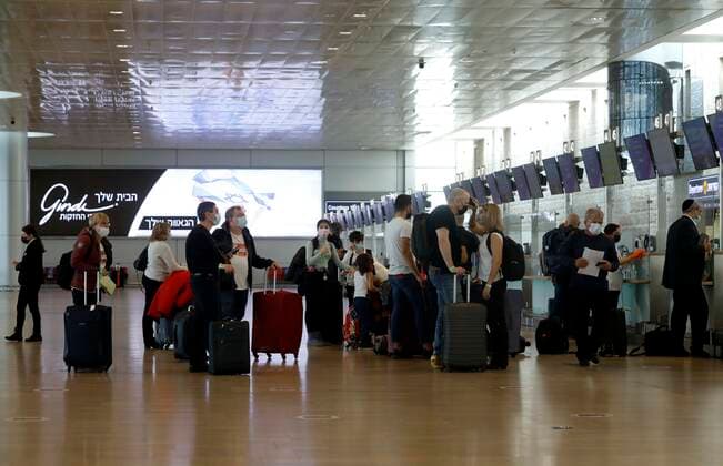 (210321) -- TEL AVIV, March 21, 2021 -- Travelers line up to check in at Ben Gurion International Airport near Tel Aviv, Israel, on March 21, 2021. Israel has lifted a restriction on the number of incoming and outgoing passengers at the airport after the Supreme Court ruled that the two-month-long measure has been unconstitutional. (Photo by Xinhua) ISRAEL-BEN GURION INTERNATIONAL AIRPORT-COVID-19-RESTRICTION-LIFTING GilxCohenxMagen 