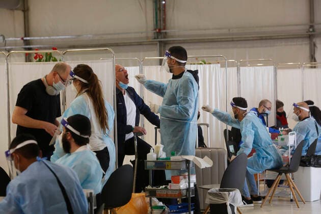 (210321) -- TEL AVIV, March 21, 2021 -- Travelers receive COVID-19 tests upon their arrival at Ben Gurion International Airport near Tel Aviv, Israel, on March 21, 2021. Israel has lifted a restriction on the number of incoming and outgoing passengers at the airport after the Supreme Court ruled that the two-month-long measure has been unconstitutional. (Photo by Xinhua) ISRAEL-BEN GURION INTERNATIONAL AIRPORT-COVID-19-RESTRICTION-LIFTING GilxCohenxMagen 