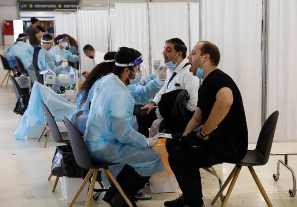 (210321) -- TEL AVIV, March 21, 2021 -- Travelers receive COVID-19 tests upon their arrival at Ben Gurion International Airport near Tel Aviv, Israel, on March 21, 2021. Israel has lifted a restriction on the number of incoming and outgoing passengers at the airport after the Supreme Court ruled that the two-month-long measure has been unconstitutional. (Photo by Xinhua) ISRAEL-BEN GURION INTERNATIONAL AIRPORT-COVID-19-RESTRICTION-LIFTING GilxCohenxMagen 