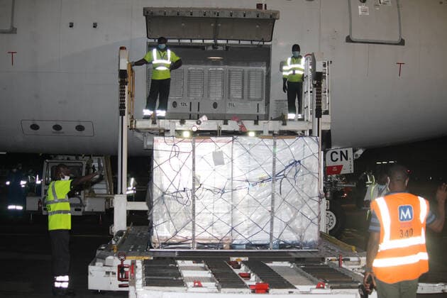 (210322) -- COTONOU, March 22, 2021 -- Workers unload a batch of COVID-19 vaccines developed by the Chinese pharmaceutical company Sinovac at Cardinal Bernadin Gantin International Airport in Cotonou, Benin, March 21, 2021. A batch of coronavirus vaccine developed by the Chinese pharmaceutical company Sinovac arrived in Cotonou, the economic capital of Benin, on Sunday evening. (Photo by Xinhua) BENIN-COTONOU-CHINESE VACCINE-ARRIVAL SeraphinxZounyekpe 