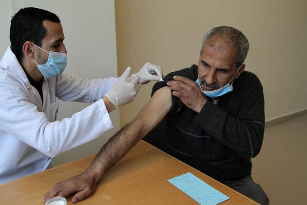 (210322) -- GAZA, March 22, 2021 -- A Palestinian man receives a dose of COVID-19 vaccine in Gaza City, March 22, 2021. (Photo by Xinhua) MIDEAST-GAZA CITY-COVID-19-VACCINATION RizekxAbdeljawad 