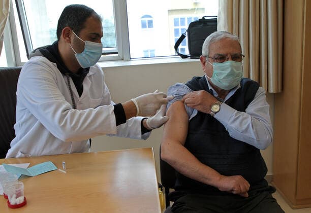 (210322) -- GAZA, March 22, 2021 -- A Palestinian man receives a dose of COVID-19 vaccine in Gaza City, March 22, 2021. (Photo by Xinhua) MIDEAST-GAZA CITY-COVID-19-VACCINATION RizekxAbdeljawad 
