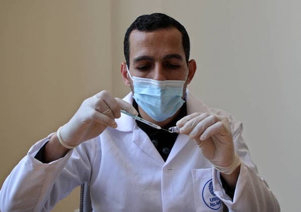 (210322) -- GAZA, March 22, 2021 -- A health worker prepares a dose of COVID-19 vaccine in Gaza City, March 22, 2021. (Photo by Xinhua) MIDEAST-GAZA CITY-COVID-19-VACCINATION RizekxAbdeljawad 