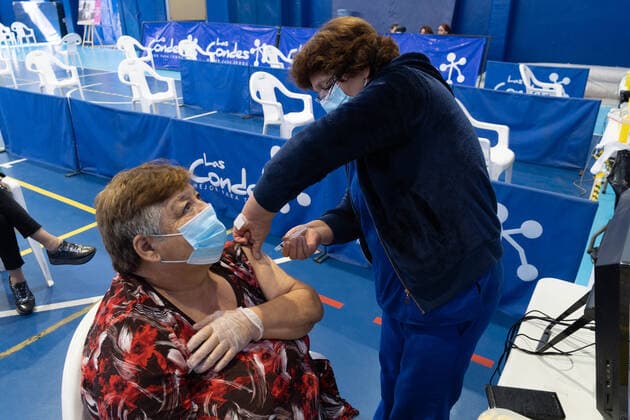 March 22, 2021, Santiago, Metropolitana, Chile: A woman receives a dose of the Sinovac vaccine, in a municipal stadium transformed into a vaccination center against covid in Santiago de Chile. Santiago Chile - ZUMAb332 20210322_zip_b332_018 Copyright: xMatiasxBasualdox