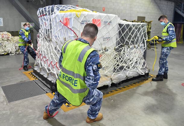 AUSMAT VACCINE PNG COVID19 RESPONSE, Royal Australian Air Force personal are seen preparing a load of COVID-19 vaccines and humanitarian for transport onto a C-17A Globemaster at RAAF Base Amberley, west of Brisbane, Tuesday, March 23, 2021. Australia are sending 8,000 doses of its COVID-19 vaccine supply to Papua New Guinea who have more than 1,400 active cases of COVID-19 and the Australian government are asking AstraZeneca and European authorities to divert another 1 million doses to Papua New Guinea. ( NO ARCHIVING, EDITORIAL USE ONLY, NO USE IN BOOKS WITHOUT CONSENT BRISBANE QLD AUSTRALIA  Copyright: xDARRENxENGLANDx 20210323001529482351
