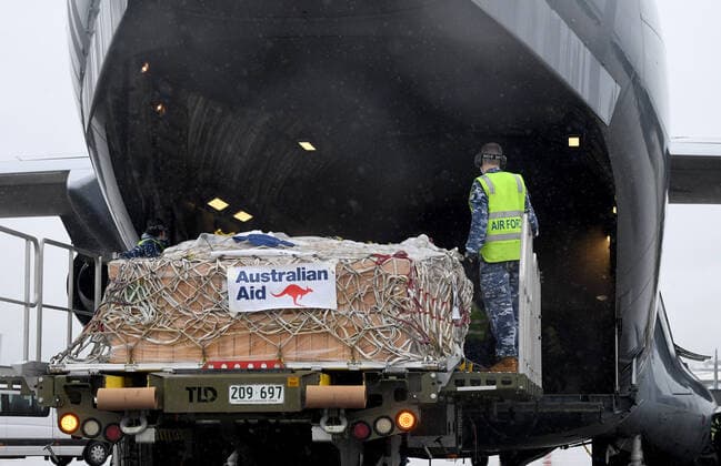 AUSMAT VACCINE PNG COVID19 RESPONSE, Royal Australian Air Force personal are seen loading COVID-19 vaccines and humanitarian supplies onto a C-17A Globemaster at RAAF Base Amberley, west of Brisbane, Tuesday, March 23, 2021. Australia are sending 8,000 doses of its COVID-19 vaccine supply to Papua New Guinea who have more than 1,400 active cases of COVID-19 and the Australian government are asking AstraZeneca and European authorities to divert another 1 million doses to Papua New Guinea. ( NO ARCHIVING, EDITORIAL USE ONLY, NO USE IN BOOKS WITHOUT CONSENT BRISBANE QLD AUSTRALIA  Copyright: xDARRENxENGLANDx 20210323001529485859